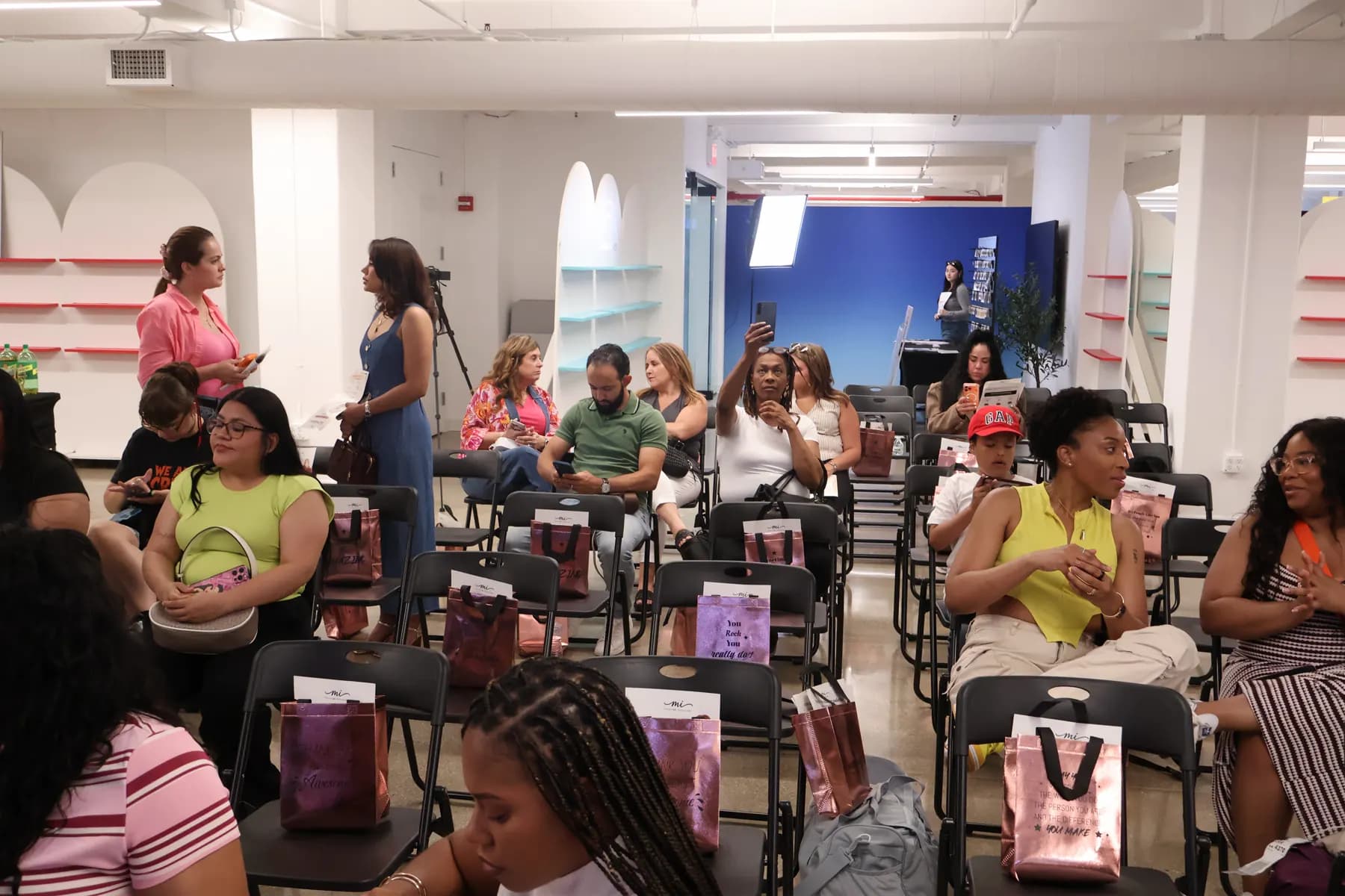 Guests gather in the seating area with MiPalette gift bags during the brand launch.