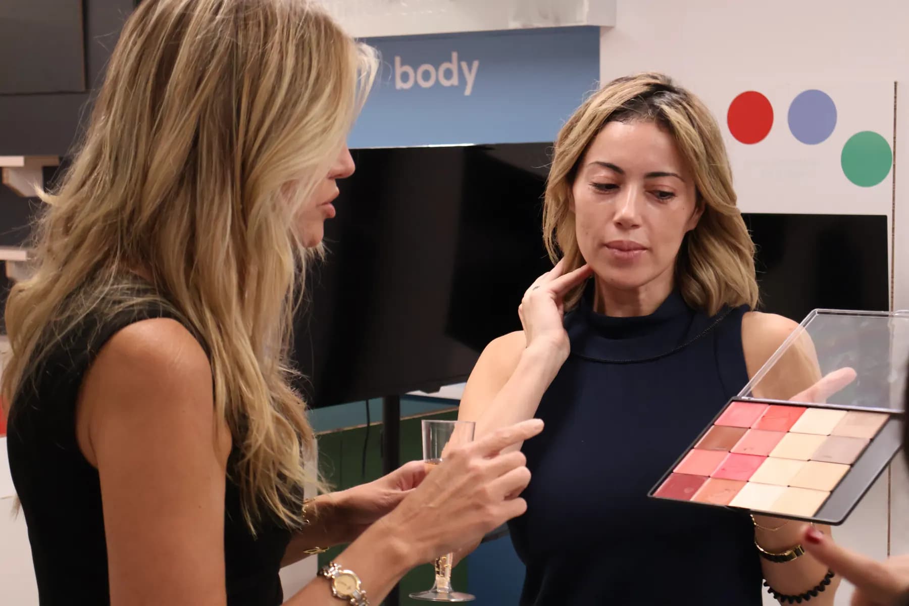 A MiPalette representative discusses colors in an open palette during a one-on-one consultation.