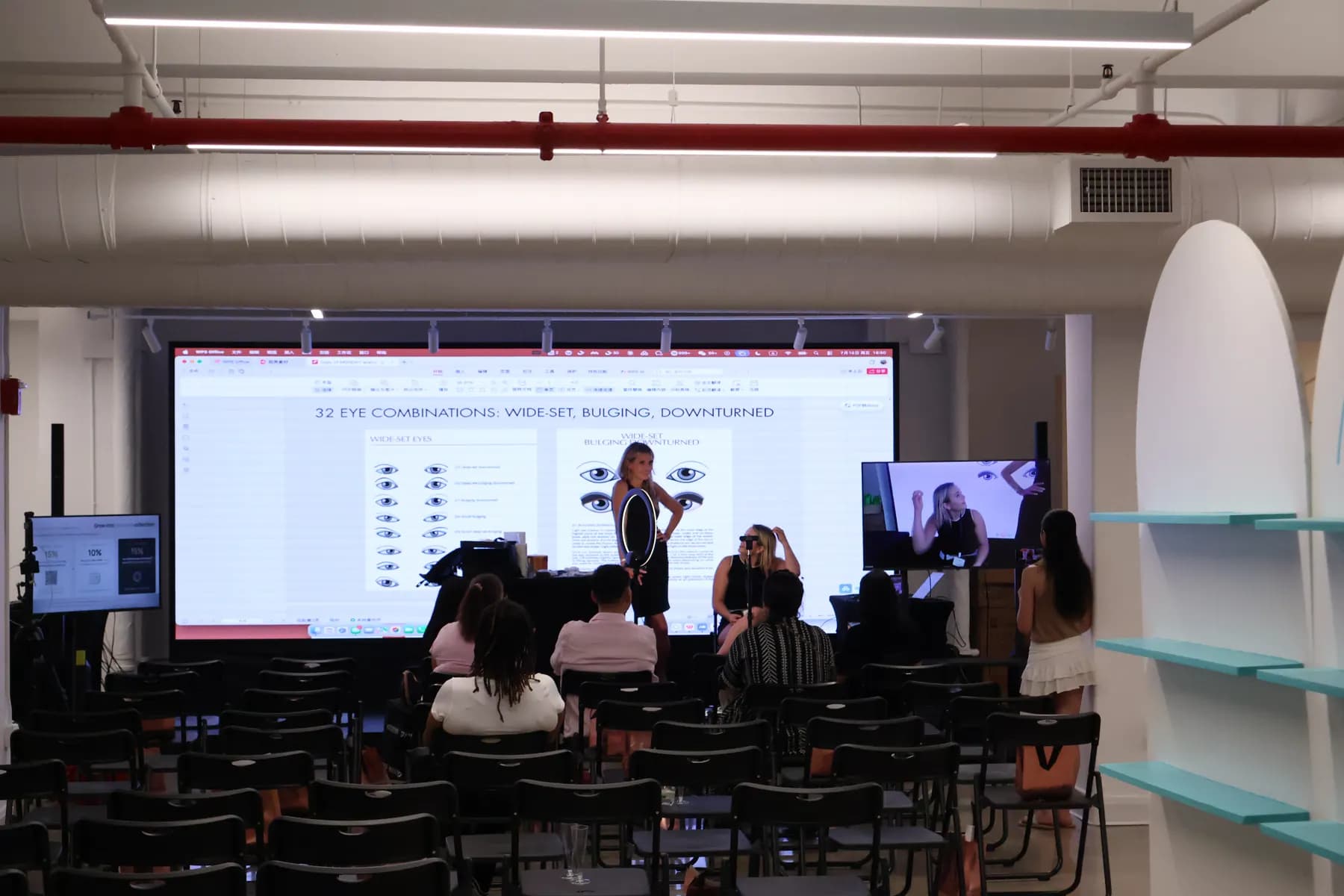 Wide view of the MiPalette brand launch presentation area with seating and a demonstration screen.