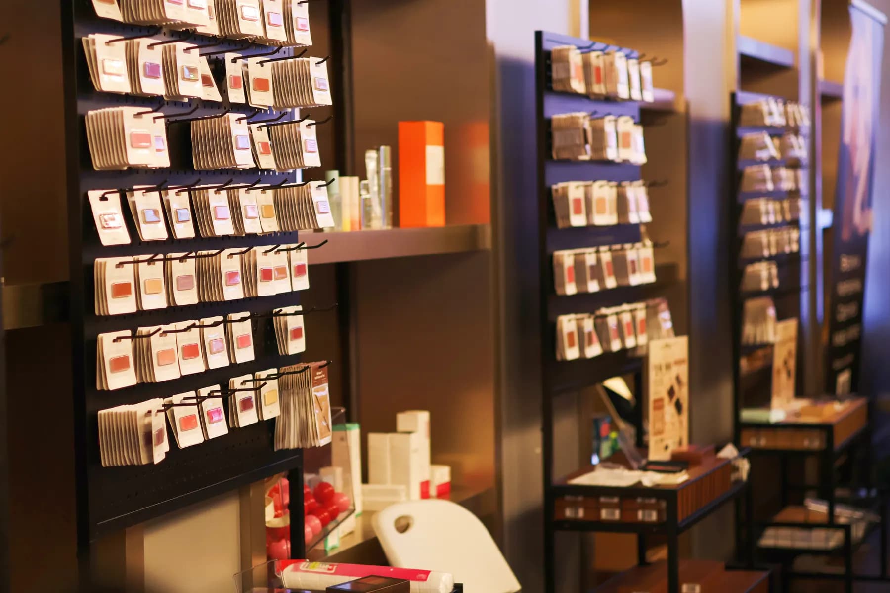 Rows of MiPalette refill shades arranged on display stands inside the pop-up.