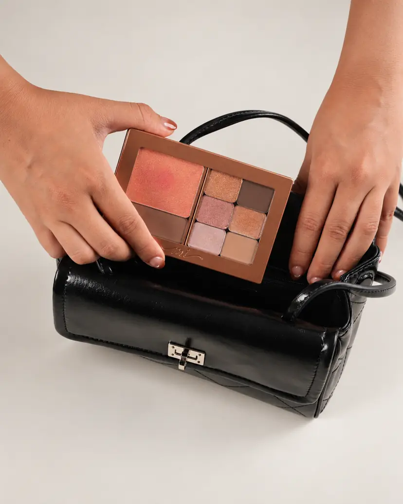 MiPalette magnetic compact held over a handbag